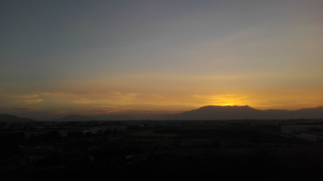 SCENIC VIEW OF MOUNTAINS AT SUNSET