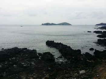 Scenic view of sea against cloudy sky