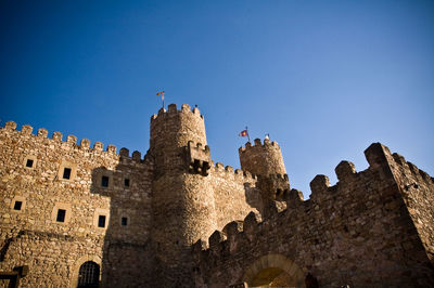 Low angle view of historic building against blue sky