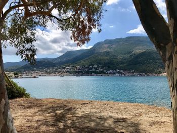 Scenic view of sea and mountains against sky