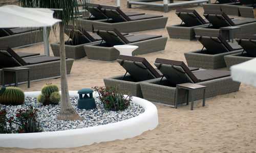 High angle view of empty chairs and tables at beach