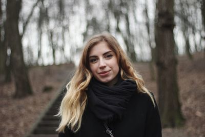 Portrait of smiling young woman in forest