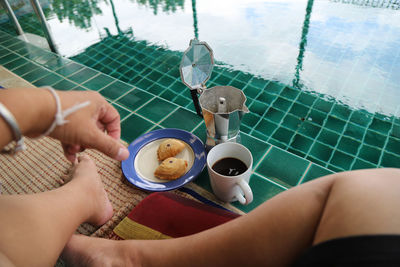 Midsection of woman holding coffee cup