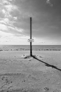 Lifeguard hut on beach against sky
