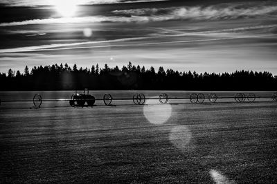 Silhouette people on field against sky