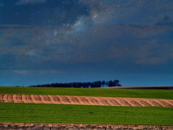 Scenic view of field against sky at night