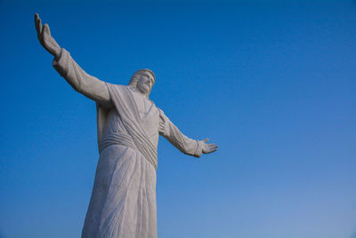 Low angle view of statue against blue sky