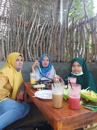 High angle view of friends sitting on table