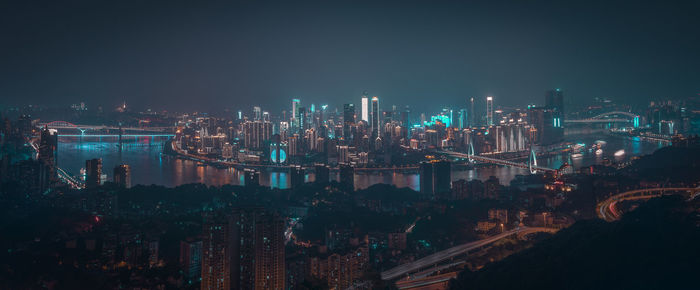 High angle view of city lit up at night