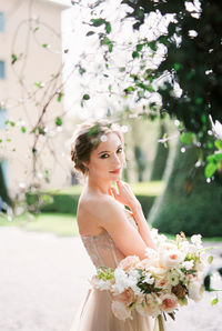 Portrait of young woman holding bouquet