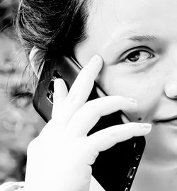 Close-up portrait of woman talking on mobile phone