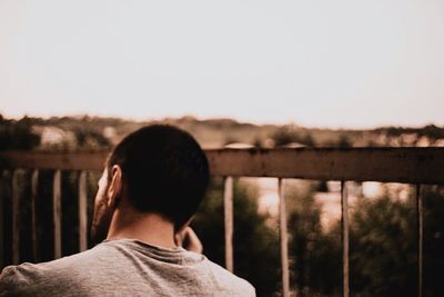 Rear view of man standing against sky