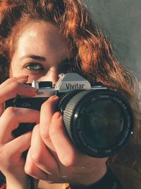 Young woman photographing camera