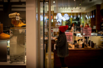 Rear view of woman standing in store