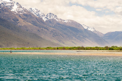 Scenic view of lake and mountains against sky