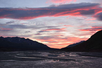 Scenic view of silhouette mountains against sky during sunset