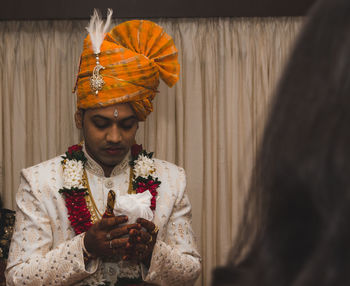 Portrait of groom praying to god on his wedding
