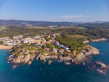 High angle view of townscape by sea against sky