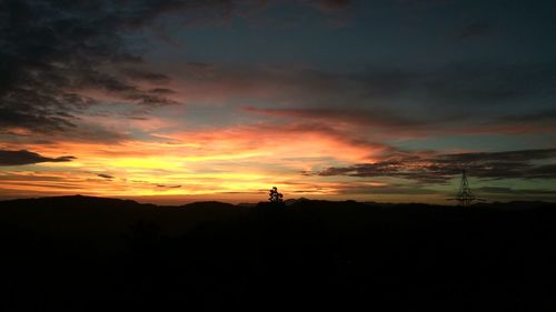 Silhouette landscape against sky during sunset