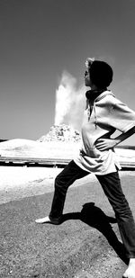 Rear view of woman on land against sky