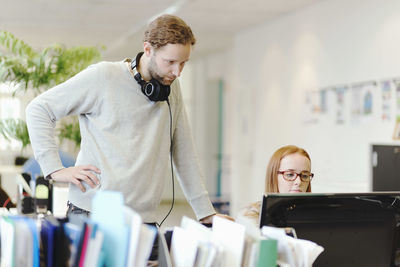 Business people using computer in creative office