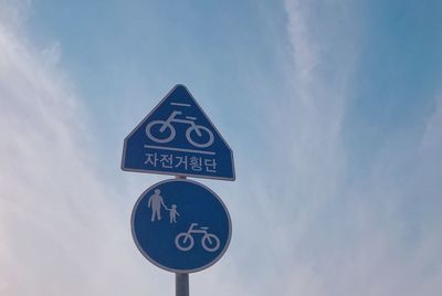 Low angle view of road sign against sky