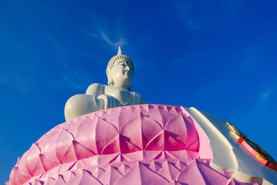 Low angle view of statue against blue sky