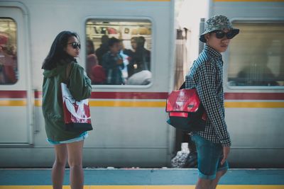 Full length of woman standing on train at railroad station