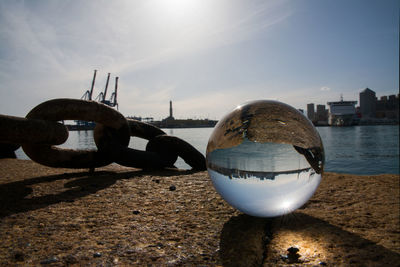 Close-up of ball on beach against sky