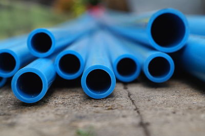 Close-up of blue pipes on footpath