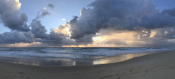 Panoramic view of beach against sky during sunset