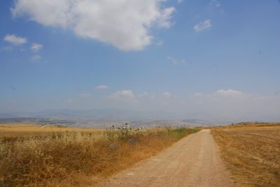 Empty road along countryside landscape