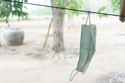 Close-up of clothespins hanging on rope