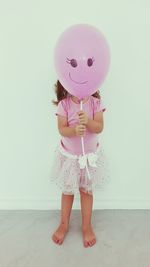 Cute girl holding balloon