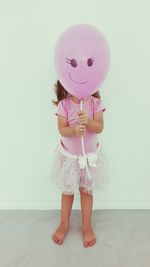 Cute girl holding balloons