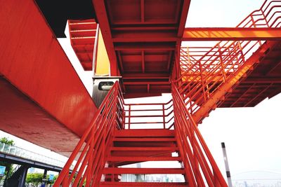 Low angle view of bridge and buildings against sky