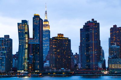 Illuminated buildings in city at dusk