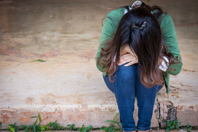 Rear view of woman standing against wall