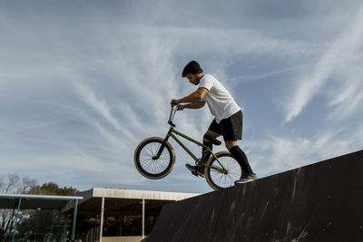 Low angle view of man riding bicycle