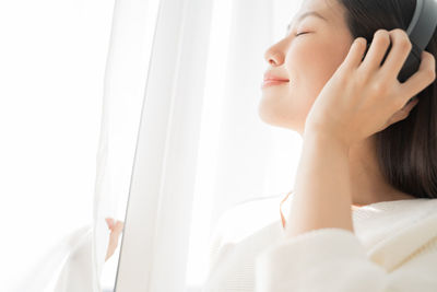 Young woman listening to music at home