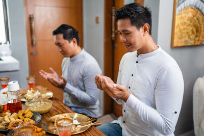 Side view of man preparing food at home