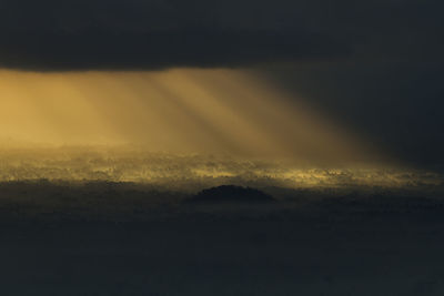 Scenic view of silhouette mountain against sky at sunset