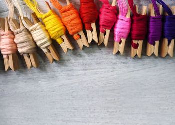 Close-up of multi colored threads on clothespins