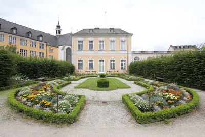 Panoramic view of garden and buildings against sky