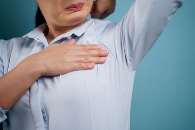 Midsection of a woman against white background