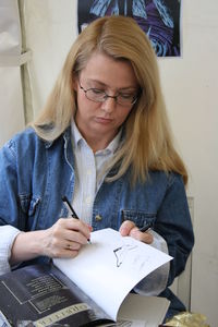 Mid adult woman sitting on paper