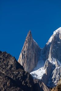 Scenic view of snowcapped mountains against clear blue sky