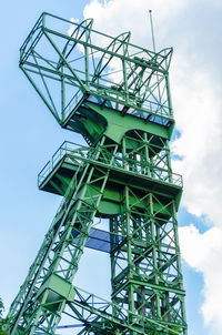 Low angle view of crane against sky