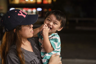 Woman carrying baby boy