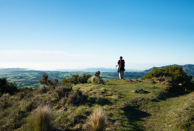 Rear view of man and woman on road against sky